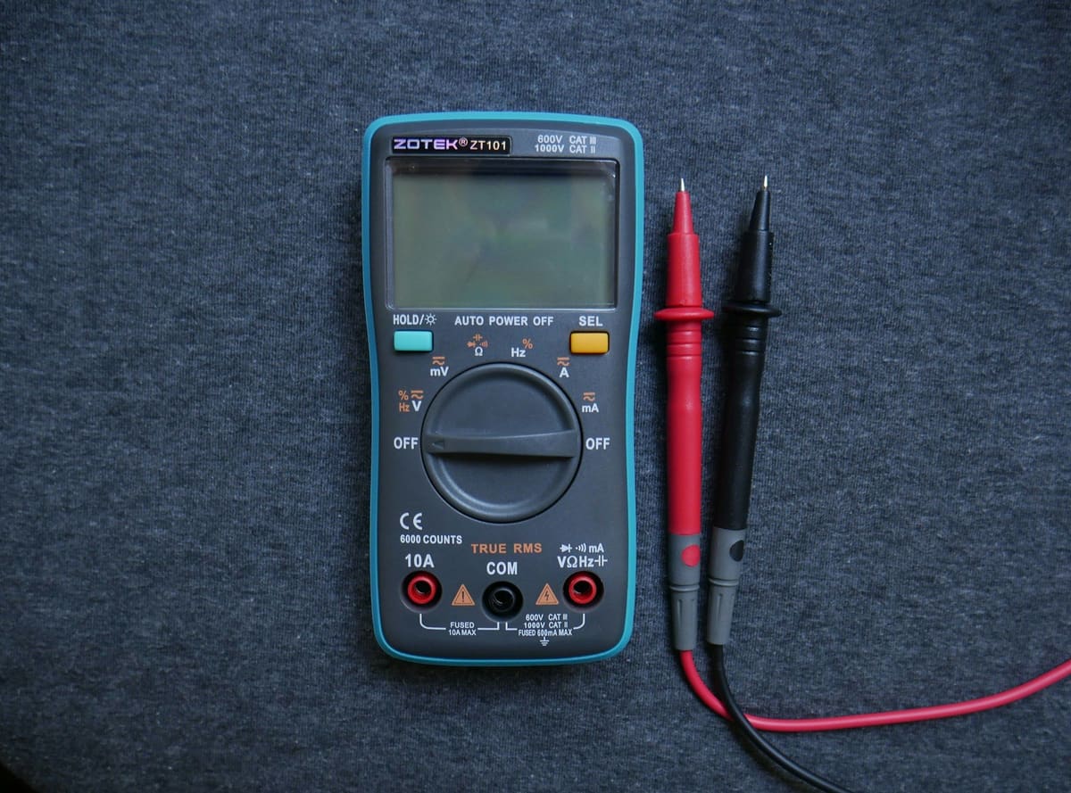 A digital multimeter with test leads, used to diagnose electrical faults